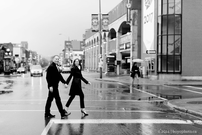 happy-couple-crossing-downtown-market-street-ottawa engagement photographer