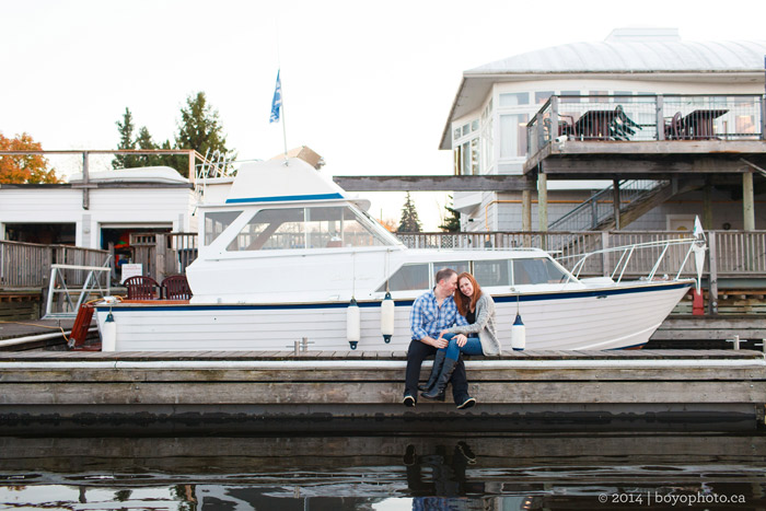 happy-couple-sitting-in-front-of-boat