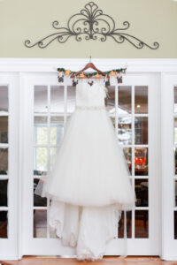 a wedding dress hangs on a wedding day