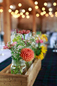 Beautiful peach and yellow flowers line a table at an Ottawa wedding venue