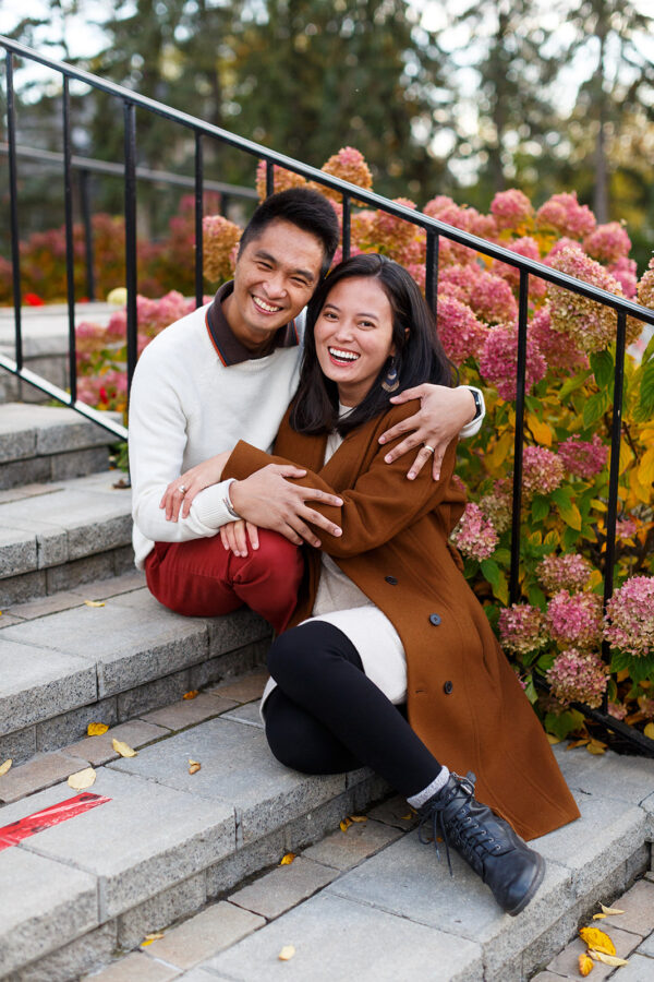 Husband and wife sitting on church steps during fall