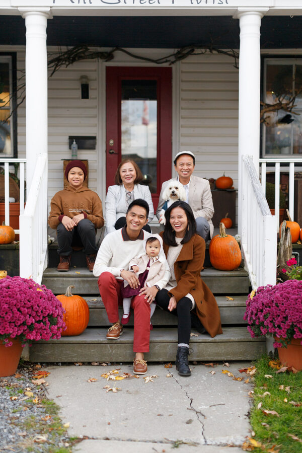 Extended family seated on heritage home steps in Manotick