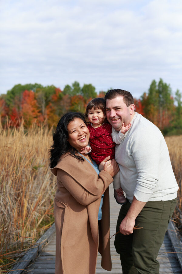 snuggling one-year-old on boardwalk at Mer Bleue Bog