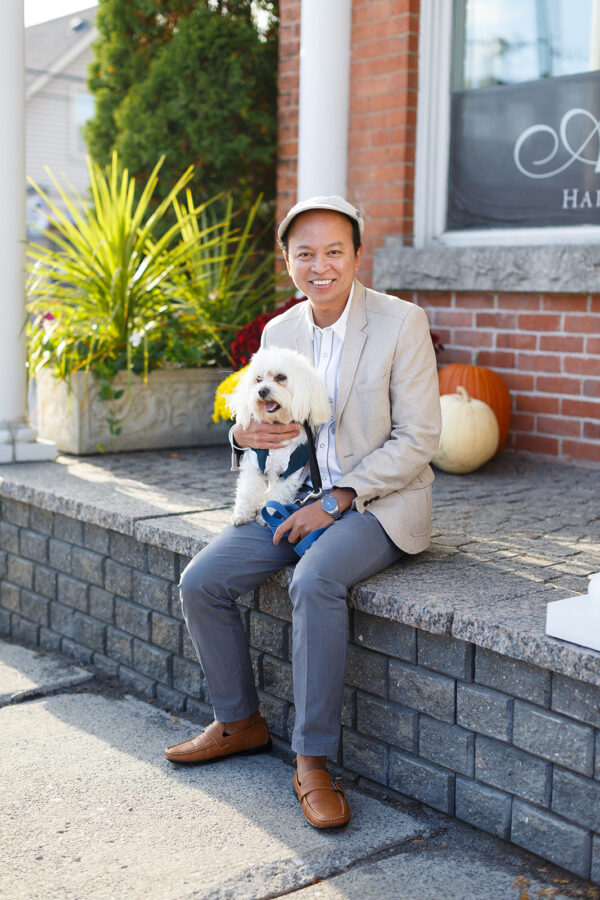 Man sitting on step with his puppy in fall